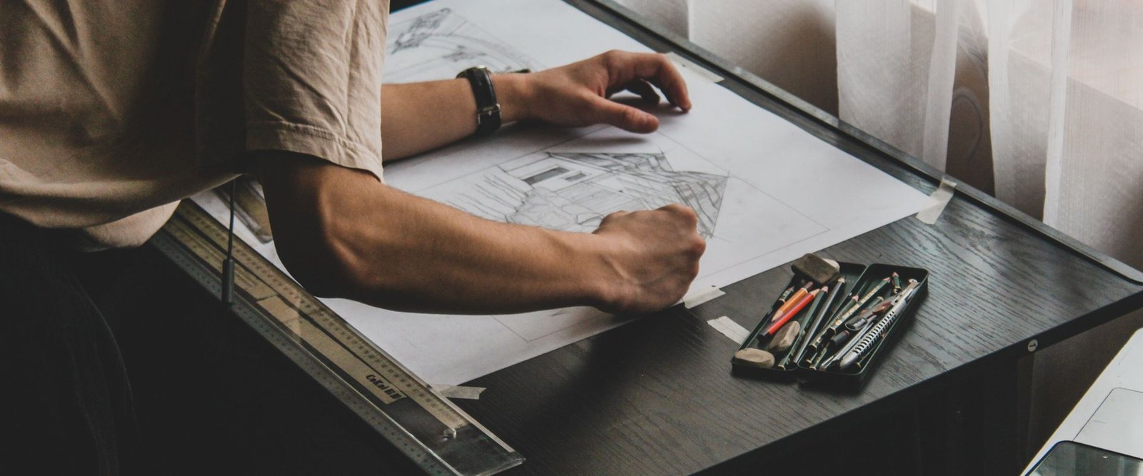 Architect sketching plans on a drafting table